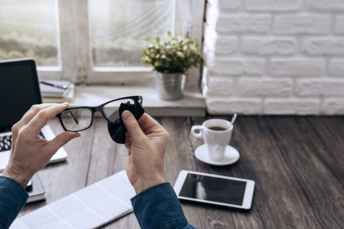 man-cleaning-glasses-PKAQUKX