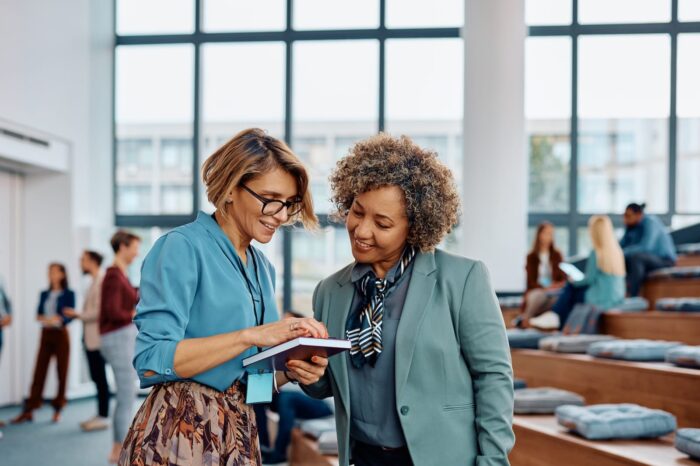 happy-female-entrepreneurs-using-cell-phone-after-2023-08-15-21-18-02-utc